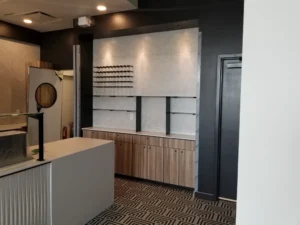 Laundry and utility cabinetry with slatted timber panelling and a fluted island
