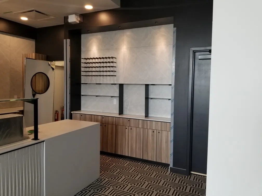Laundry and utility cabinetry with slatted timber panelling and a fluted island