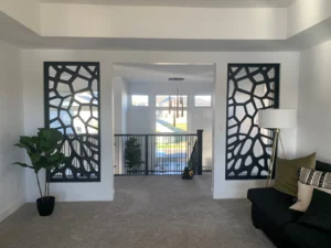 Black CNC cut screens set either side of an upper hallway opening