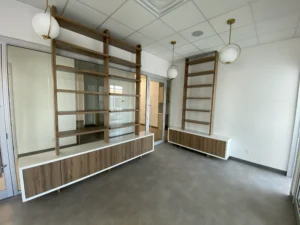 Open shelving and low storage units built into an office reception area